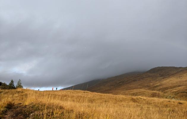 Image of people walking up a hill