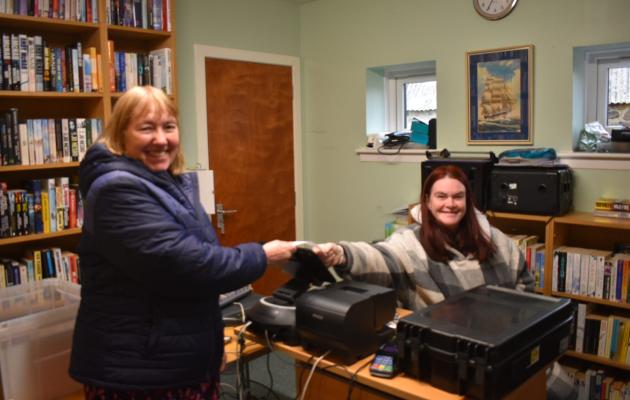 Two people smiling in a room together