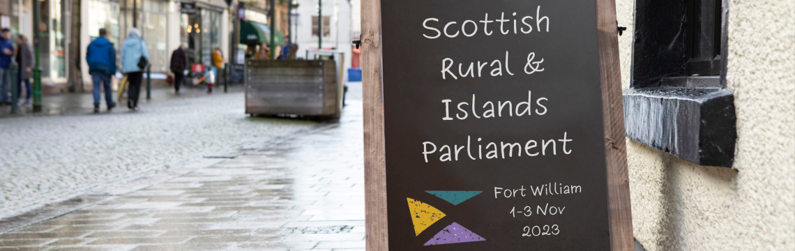 Placard on street in Fort William with text 'Scottish Rural and Islands Parliament'