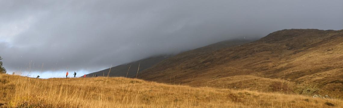 Image of people walking up a hill